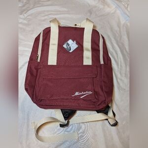 Burgundy Michelin Backpack With Michelin Man Rolling A Tire